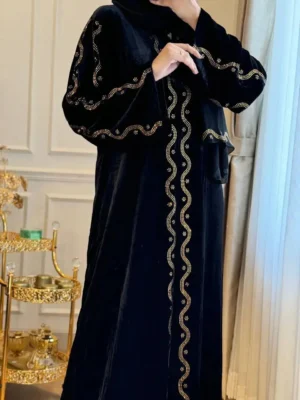 Luxury black velvet abaya with intricate gold embroidery, perfect for modest fashion and traditional Islamic wear.